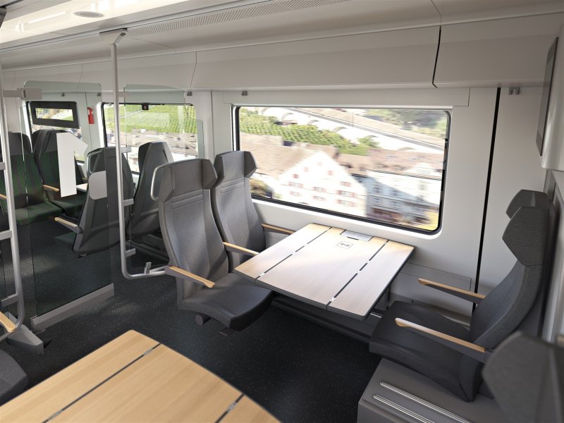 De eerste klas coup� met tafels voorzien van een draadloze oplader voor smartphones. (Foto: Siemens Mobility)